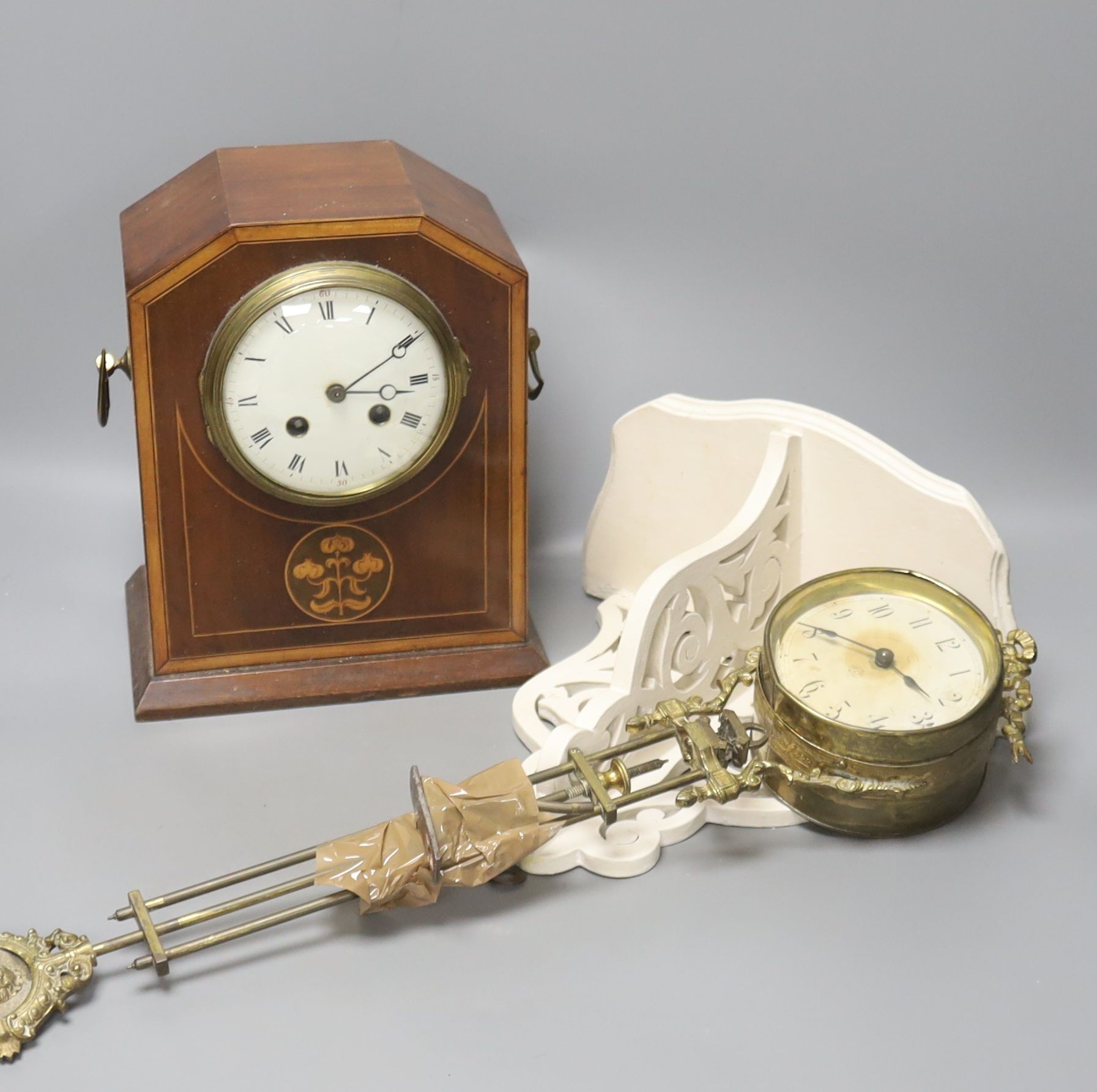 An incomplete late 19th century brass mystery timepiece, a painted wall bracket and an inlaid mahogany mantel clock